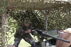 The oldest member of the Heathens reenactment group with a replica 50 caliber machine gun.