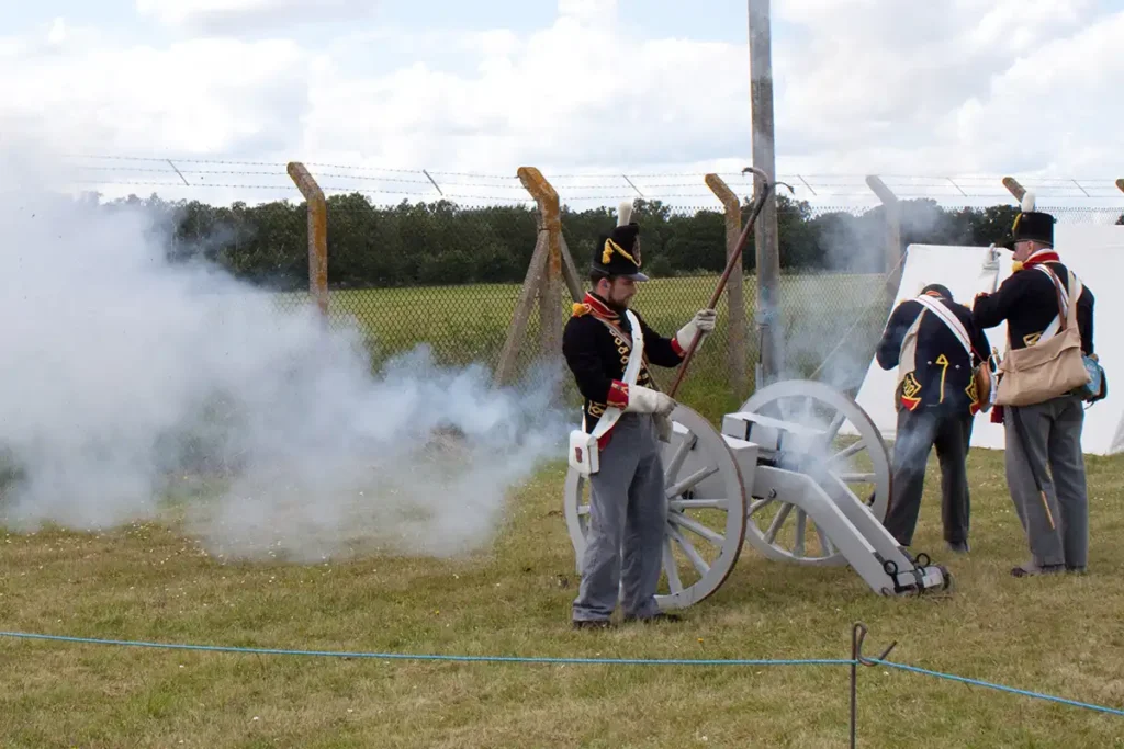 An image of the napoleonic era reenactment group firing their cannon.