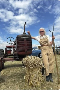 A picture for the Suffolk Women's Land Army with a tractor and chaff of wheat.